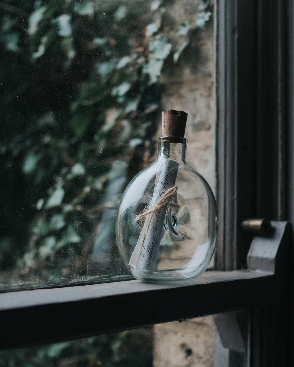 Message in a bottle on a window ledge