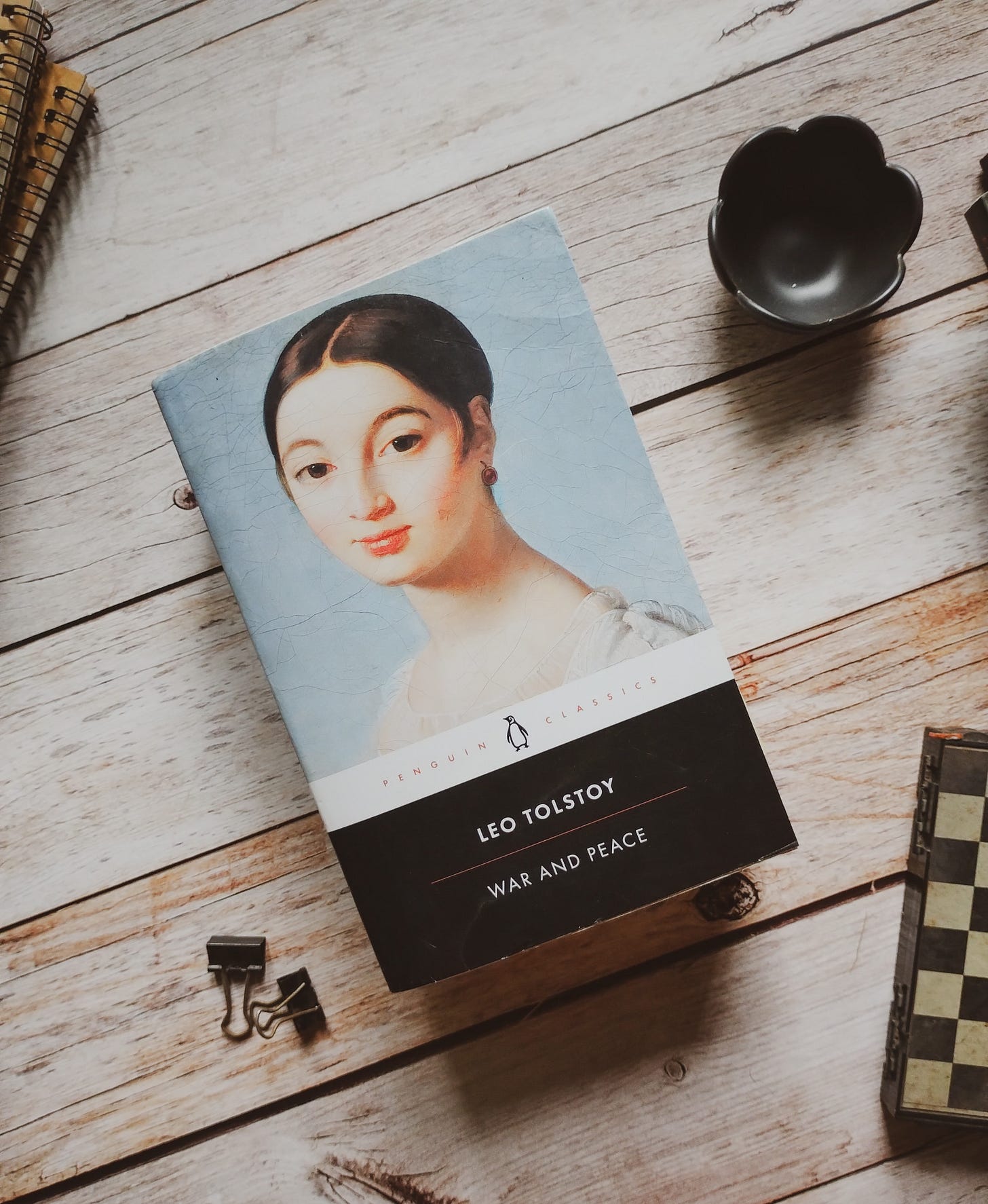 Penguin black classics, War and Peace by Leo Tolstoy, on a wooden table