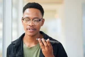 Shot of a young businessman using a smartphone in a modern office