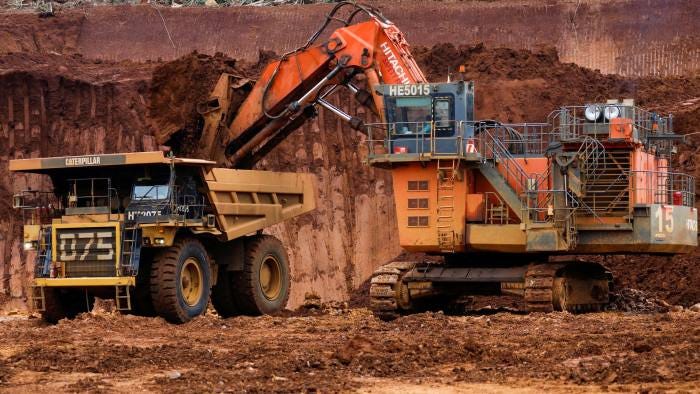 An excavator loads raw nickel ore into a dump truck at a Vale nickel mining site in Indonesia