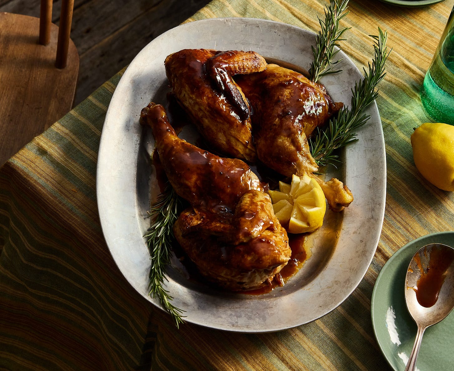 Braised chicken in white wine on a metal platter.