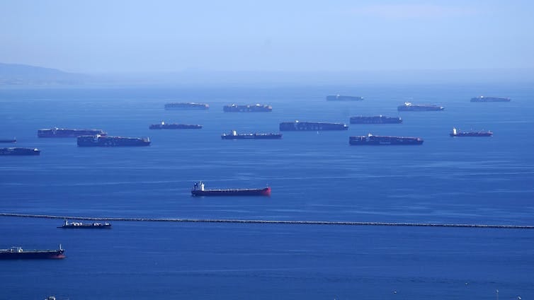 cargo ships at anchor offshore