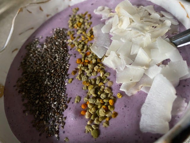 smoothie bowl with chia seeds, pollen, and coconut flakes