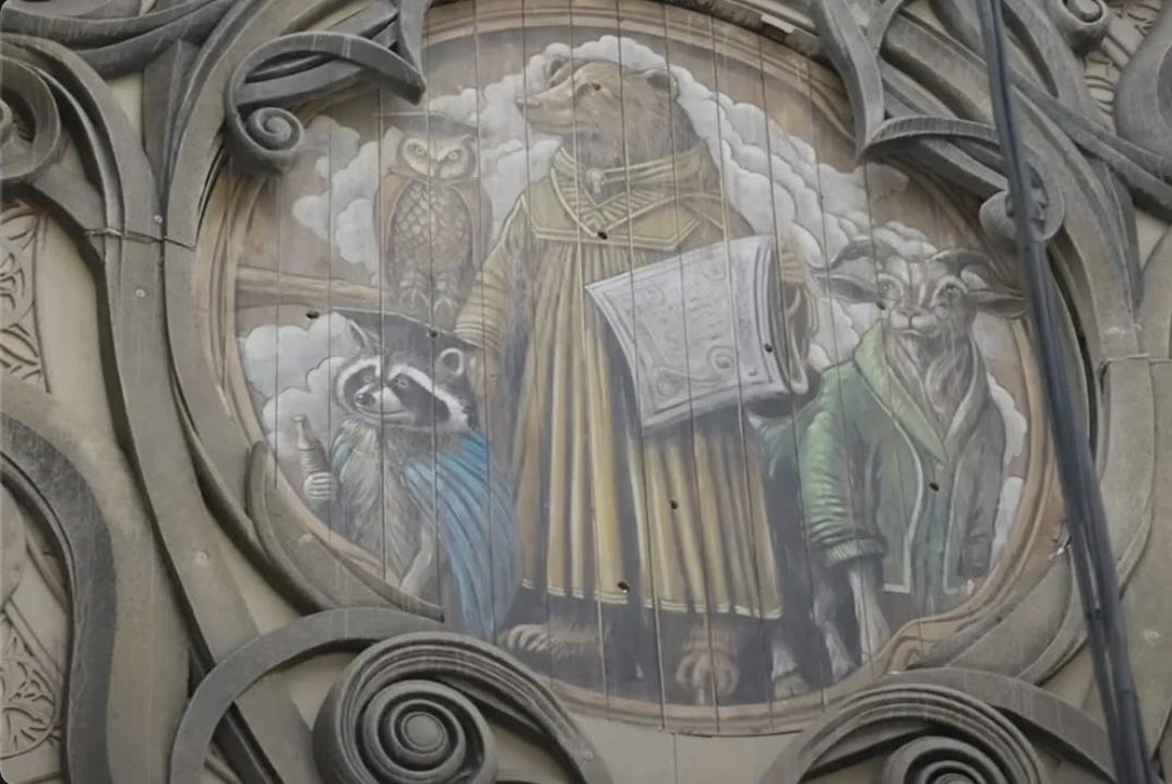 A mural depicting an owl, a raccoon, a bear, and a goat wearing robes.