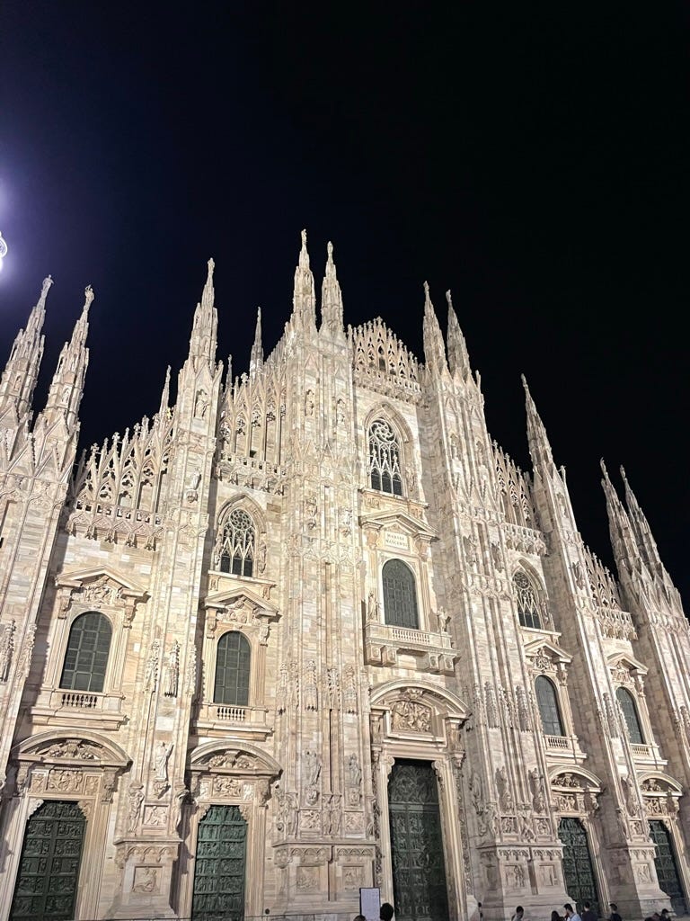 The MIlan duomo lit up at night.