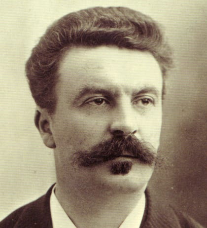 A black and white photograph of French writer Guy de Maupassant by Nadar around 1888, showing his face with a mustache and a goatee at about 38 years old 