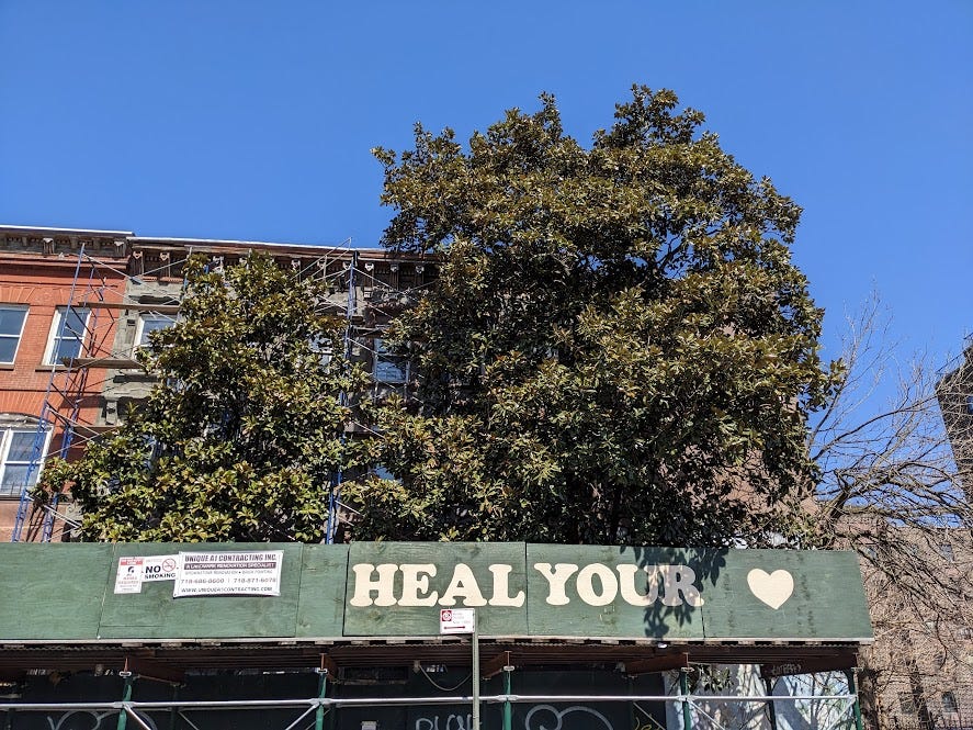 construction awning reads "Heal Your Heart"