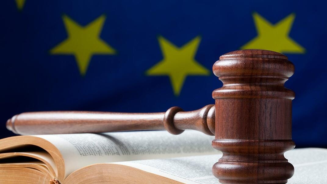 A gavel, hitting the block, in front of an EU flag