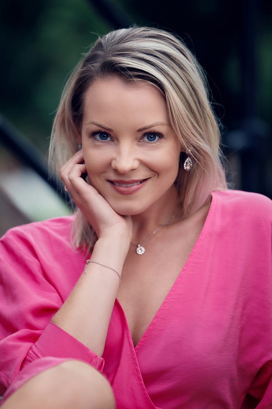 Woman smiling, pink dress suit