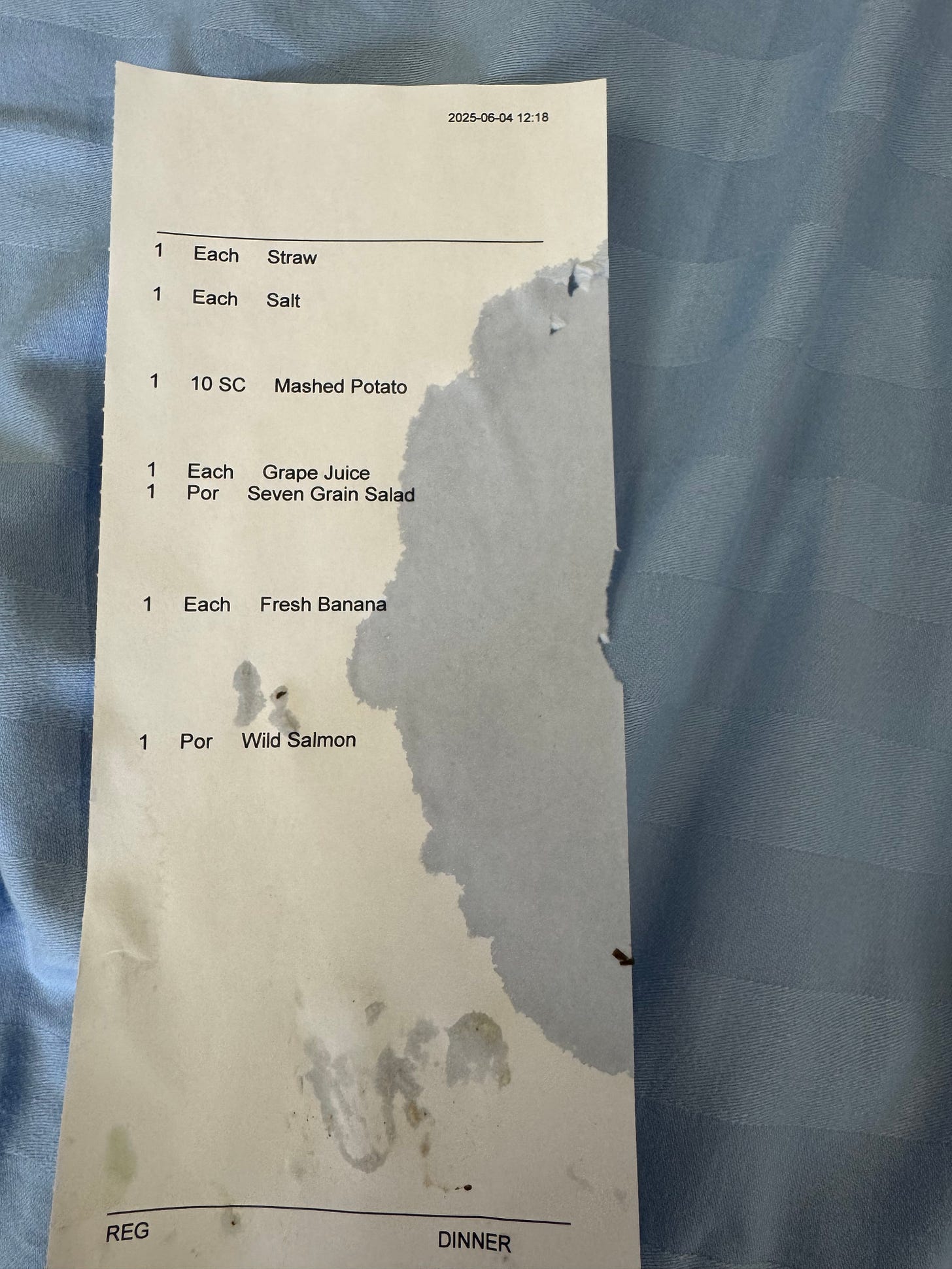 Dinner menu with a water stain in the shape of Alfred Hitchcock's profile
