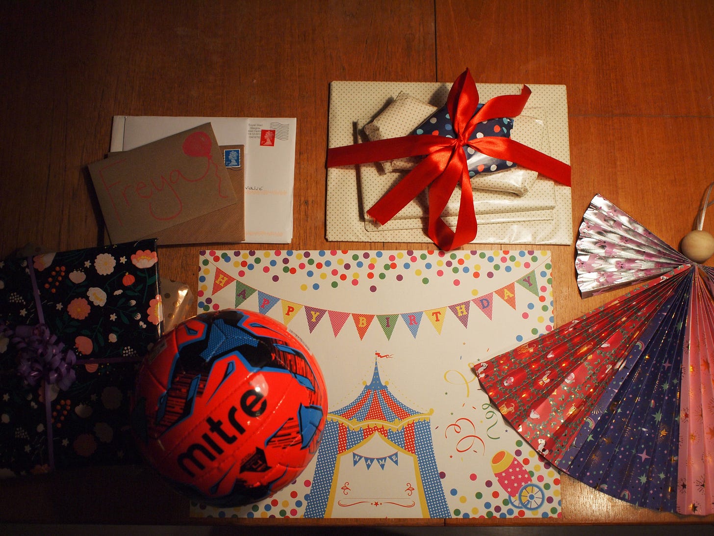 A table setting for birthday morning featuring presents and cards