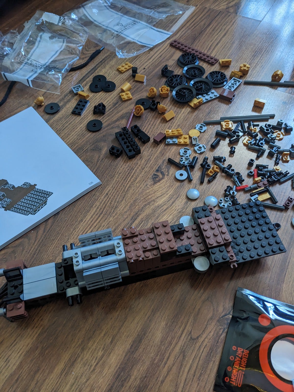 A not yet built offbrand lego train with pieces strewn around the beginnings of the train