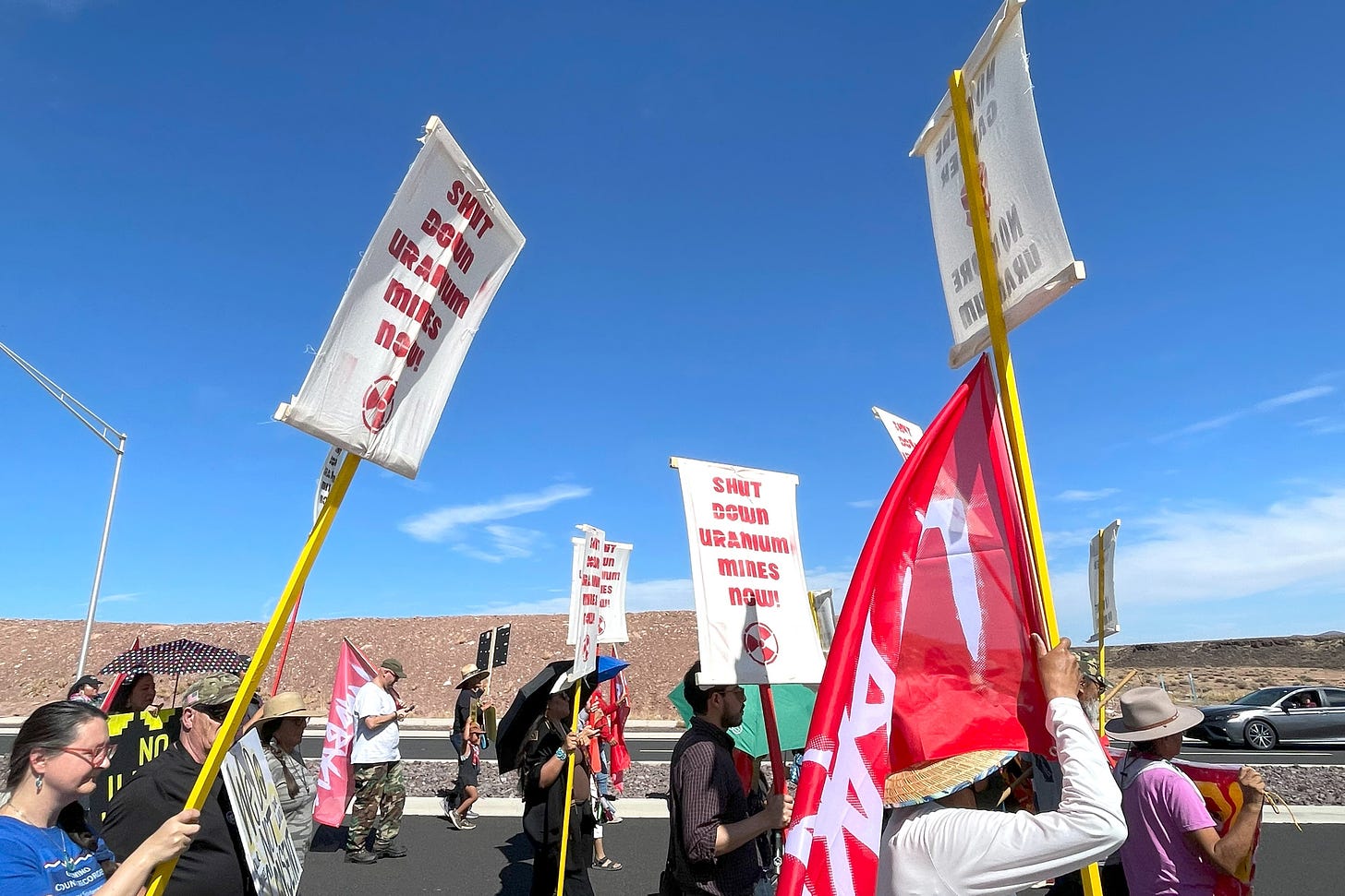 Participants in the "No Illegal Uranium Hauling" walk proceed along U.S. Route 89 on Friday in Cameron, Arizona. Credit: Noel Lyn Smith/Inside Climate News