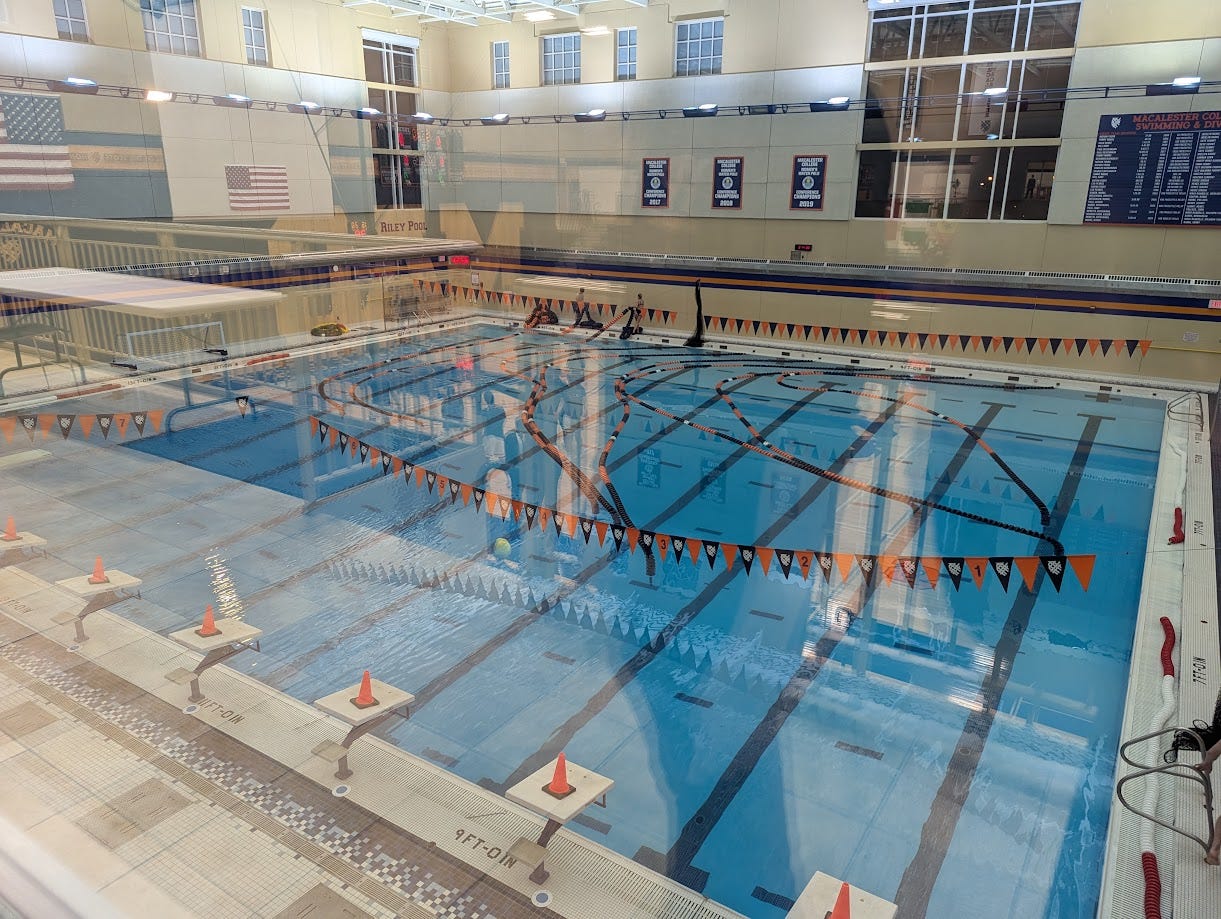 The natatorium, as viewed through the window from the gymnasium...the pool's lane dividers are strung out all over the place.