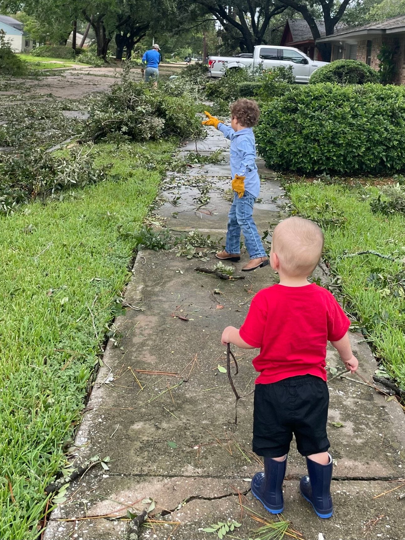 Two young boy picking up debris after Hurricane Beryl Two young boy picking up debris after Hurricane Beryl