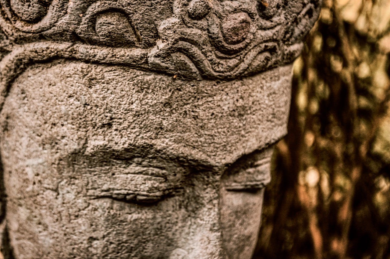 The head of a statue with closed eyes, deep in thought