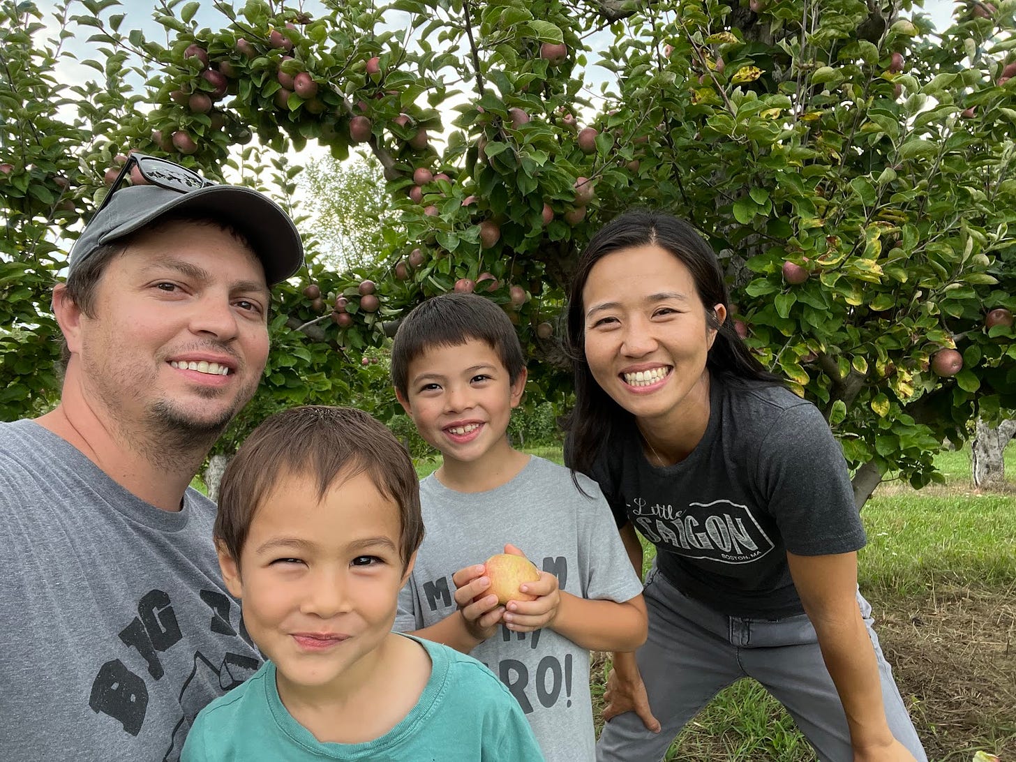 Michelle and the family smile for a selfie at the apple orchard