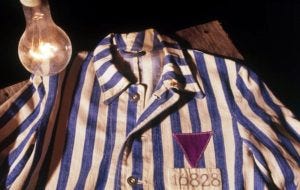 A historical artifact from World War II shows the purple triangle that Jehovah’s Witnesses were made to wear in the camps.