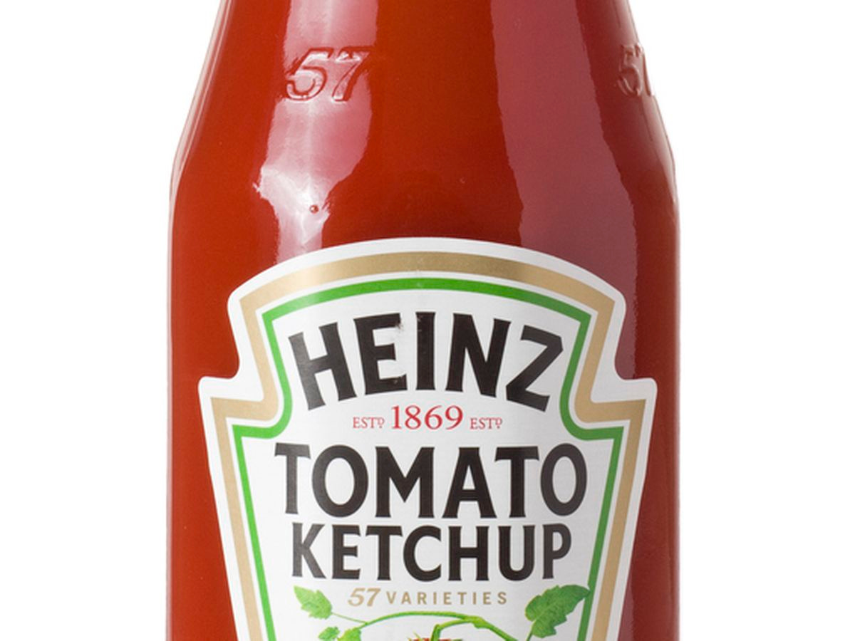 A bottle of ketchup, with the Heinz Tomato Ketchup label visible. It says "Heinz Tomato Ketchup Est. 1869; 57 varieties""