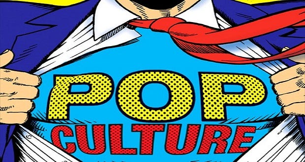 This image shows a color drawing of Superman's torso as he rips open his clothes to reveal the words "Pop Culture" where his famous "S" symbol would otherwise be. This image only shows Superman's chest, cutting off his head and his lower abdomen. His hands are seen holding his suit jacket and shirt open over a blue undershirt bearing the word "Pop" (in yellow polka dots) atop the word "Culture" (in red polka dots). This image shows a color drawing of Superman's torso as he rips open his clothes to reveal the words "Pop Culture" where his famous "S" symbol would otherwise be. This image only shows Superman's chest, cutting off his head and his lower abdomen. His hands are seen holding his suit jacket and shirt open over a blue undershirt bearing the word "Pop" (in yellow polka dots) atop the word "Culture" (in red polka dots).
