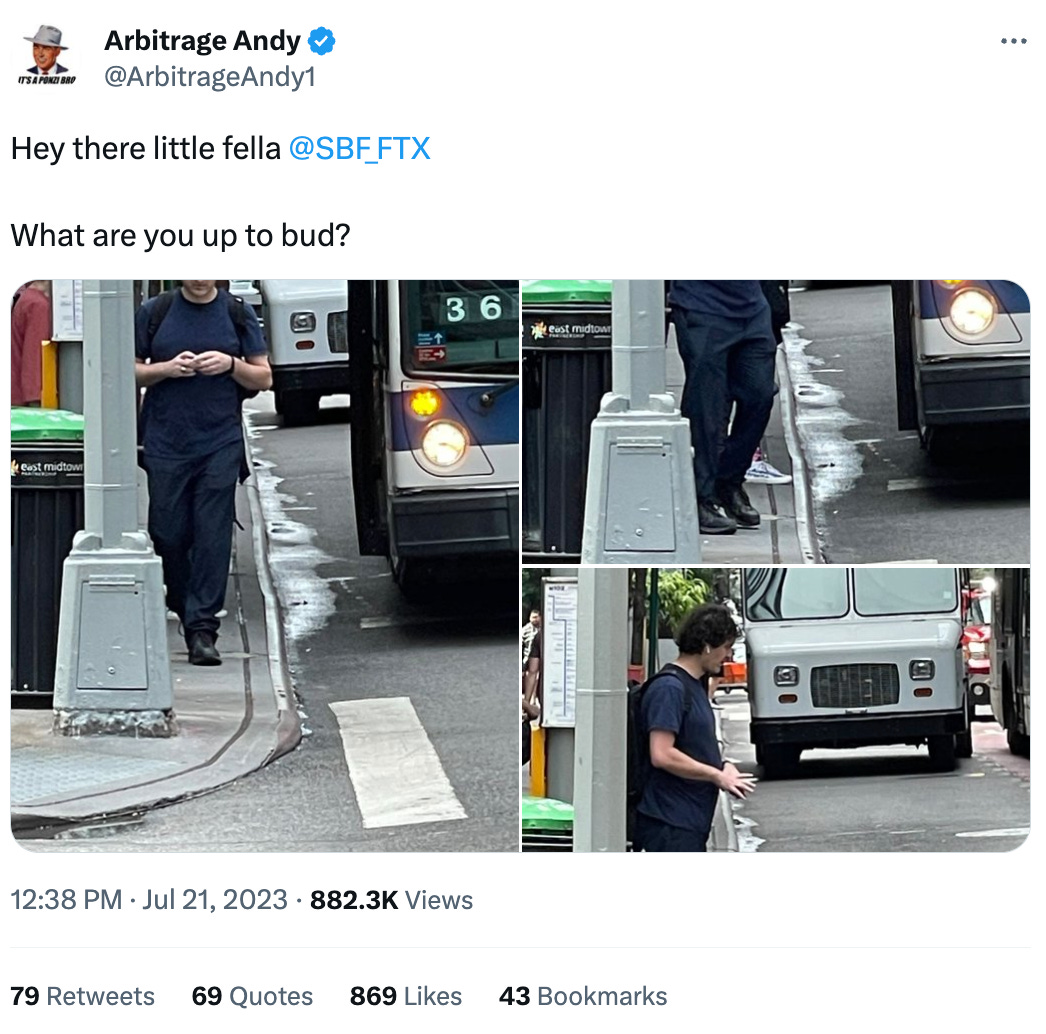 Tweet by Arbitrage Andy (@ArbitrageAndy1): Hey there little fella @SBF_FTX What are you up to bud?   Tweet contains three images of Sam Bankman-Fried, wearing a navy t-shirt, slacks, black sneakers, airpods, and a backpack walking down a sidewalk in a city.