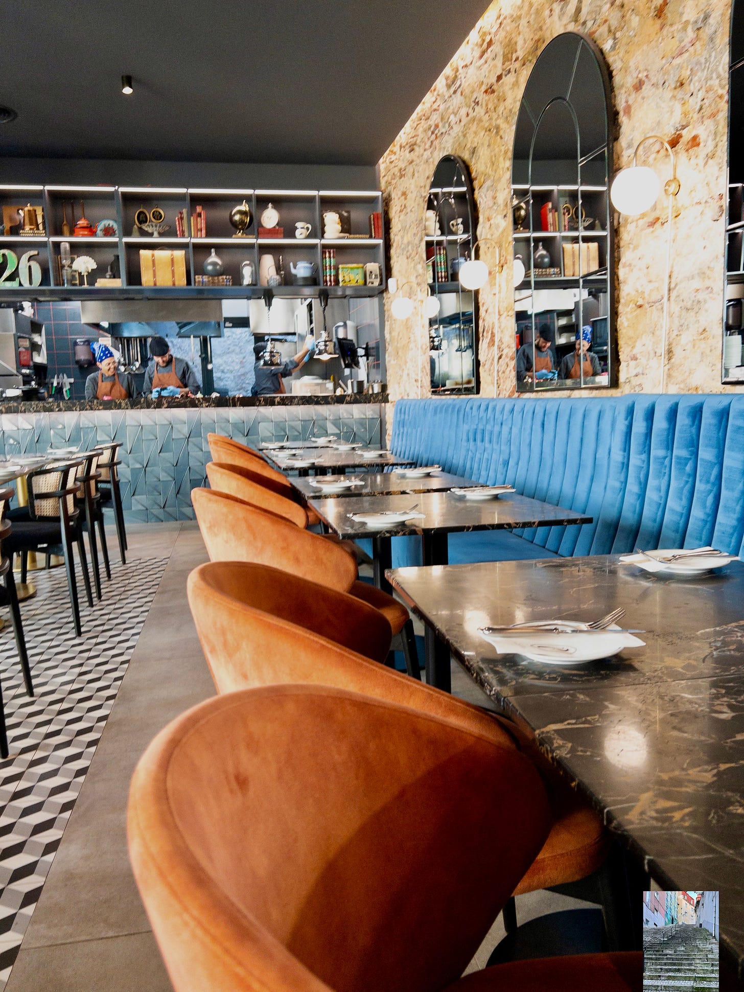 An elegant vegan food restaurant in LIsbon with warm burnt orange and blue colors in its decor