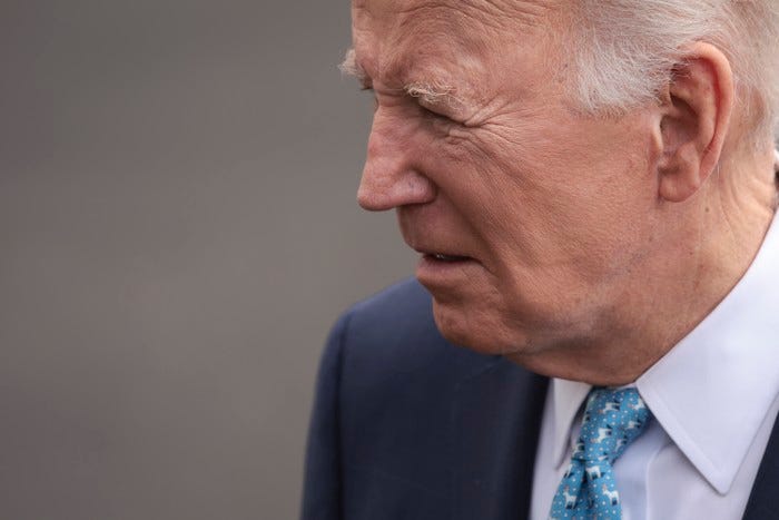 A photo of Joe Biden's face from the side while he looks down