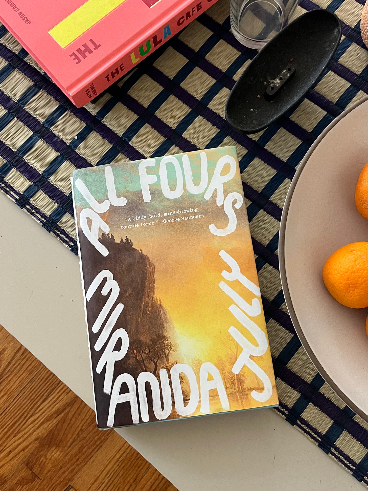 All Fours by Miranda July in hardcover sitting atop a coffee table.