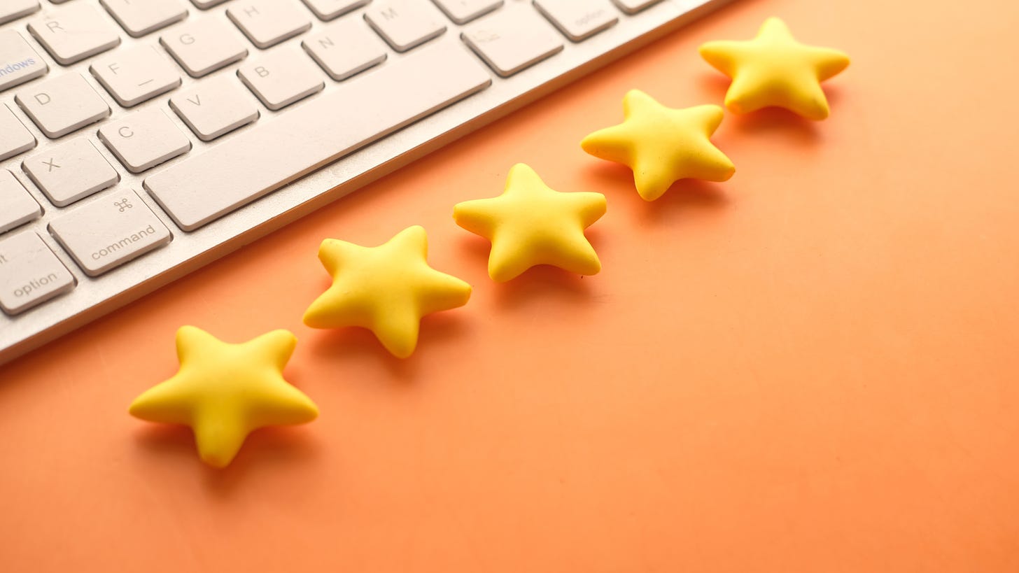 Five yellow stars on orange background with a keyboard