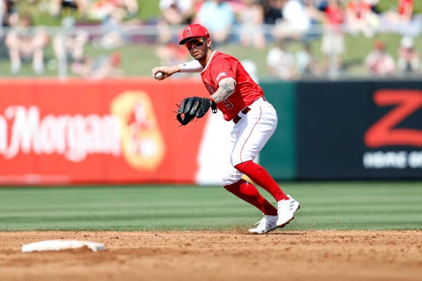 Zach Neto of the Los Angeles Angels throws to first base during a spring training game against the Cincinnati Reds at Tempe Diablo Stadium on March...