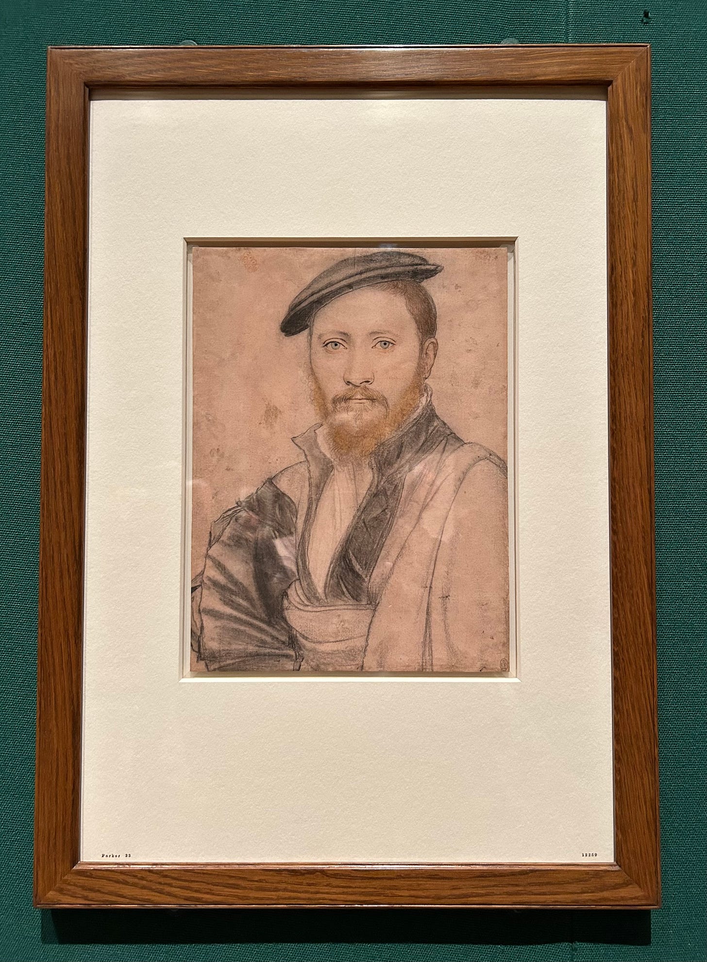 A drawing of a young man with beard and hat staring straight at the painter. This is a C16th drawing.