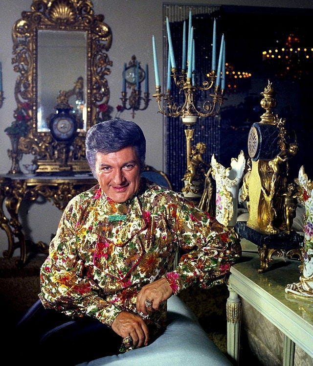 Photograph of Liberace in his opulent home.