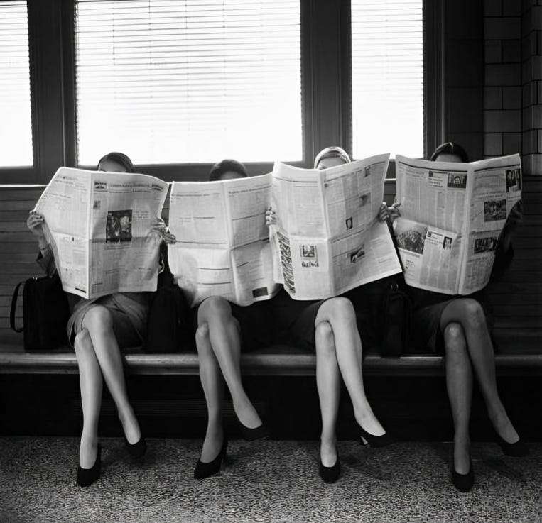 Four women sitting side by side on a bench, all holding up newspapers that completely cover their faces. The image, in black and white, captures a playful yet reflective moment of people immersed in catching up with the news. Their identical positioning emphasizes the importance of staying informed in today’s fast-paced world.