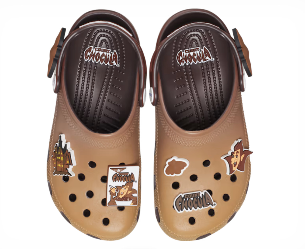 A pair of brown Count Chocula branded clogs with cereal-themed Jibbitz