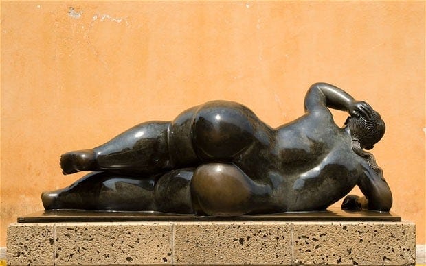 Statue of a woman reclining by Fernando Botero in the Plaza de Santo Domingo, Cartagena de Indias, Colombia