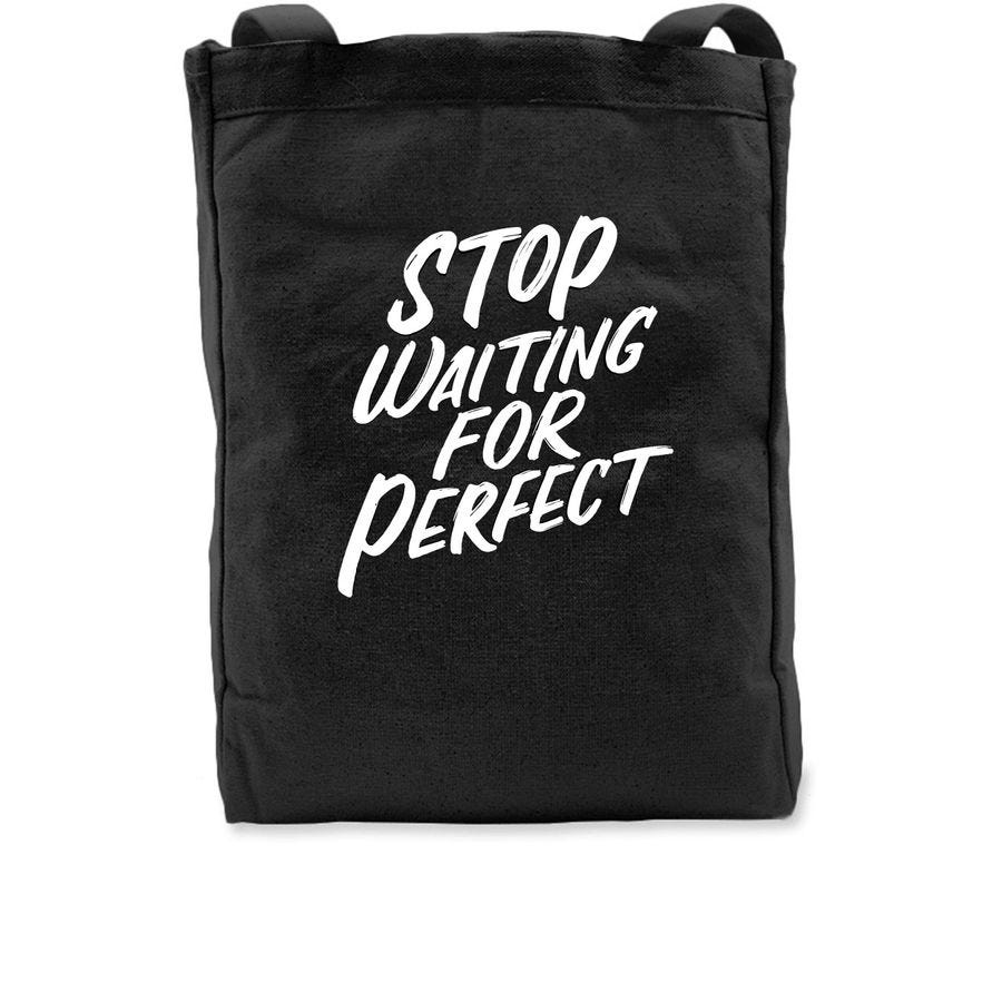 Picture of a black tote with white lettering, Stop Waiting for Perfect