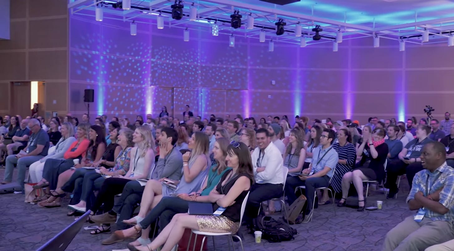 video still of audience at a conference