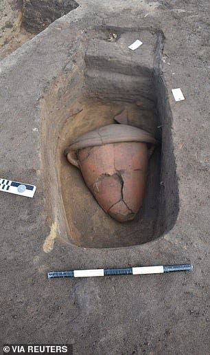 A cultural relic unearthed from a tomb is pictured at the Nile Delta, showing a pot buried in a tomb