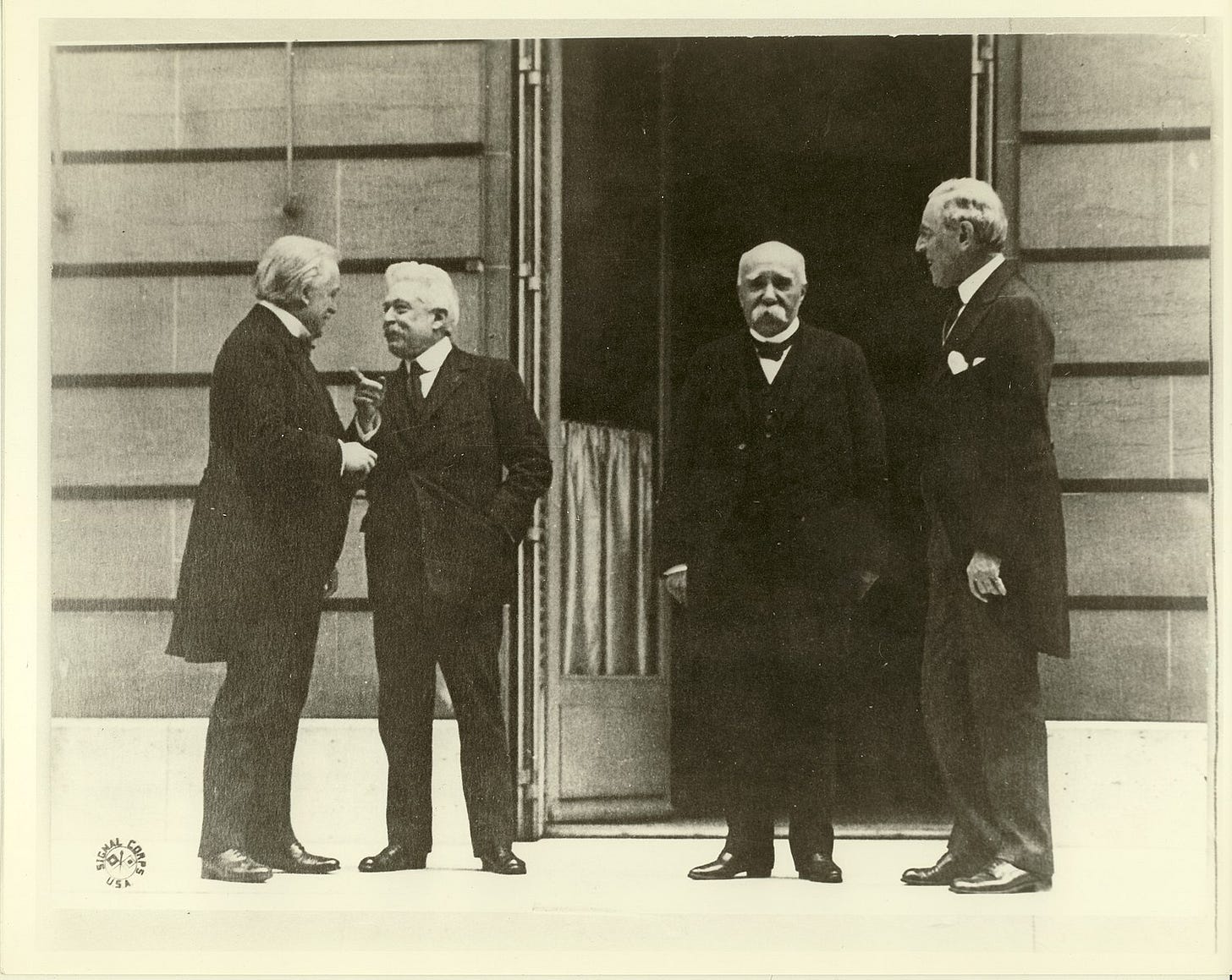 A group of men standing outside a building
Description automatically generated A group of men standing outside a building
Description automatically generated