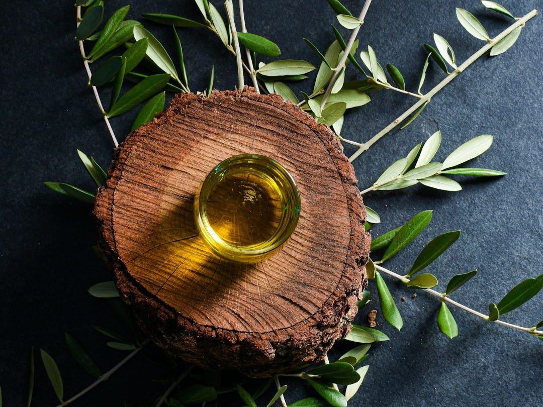brown round wooden ornament on green leaves