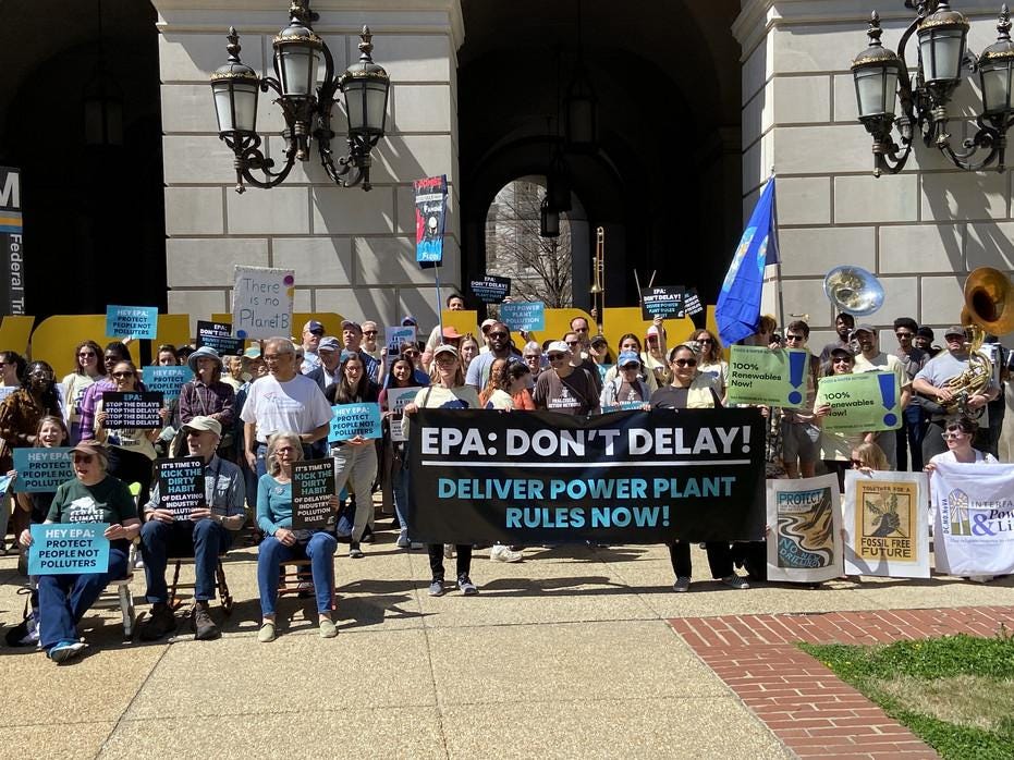 A group of protesters with a sign that says &quot;EPA: Don't delay. Deliver power plant rules now!&quot;