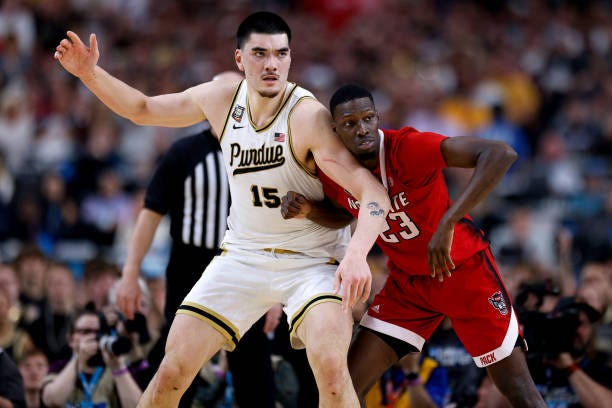 Zach Edey of the Purdue Boilermakers calls for the ball while defended by Mohamed Diarra of the NC State Wolfpack during the second half in the NCAA...