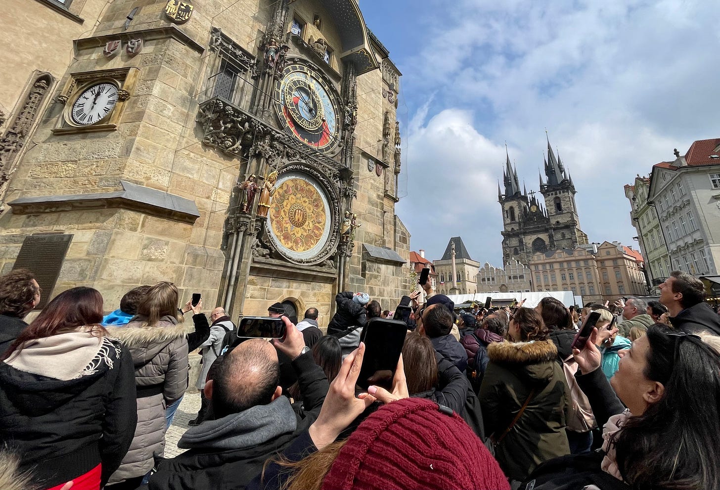 Crowds wait for the clock to strike the hour in Prague