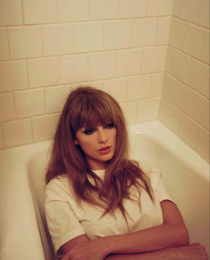This may contain: a woman sitting in a bathtub with her arms crossed This may contain: a woman sitting in a bathtub with her arms crossed