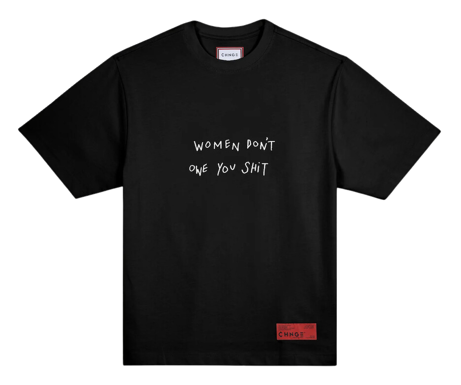 A black t-shirt with white embroidery that reads "Women don't owe you shit."