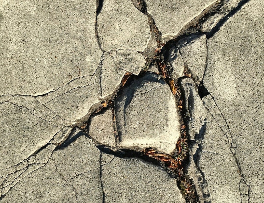 close-up photo of broken concrete wall close-up photo of broken concrete wall