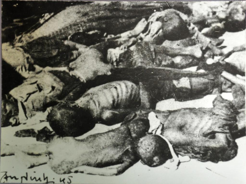 A historical black-and-white photograph showing the aftermath of the My Lai Massacre, with victims lying on the ground. The image serves as a stark reminder of the tragic events during the Vietnam War.