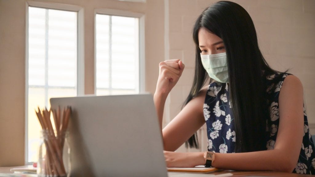 Girl wearing a mask with confident gestures.She works at home to protect against the Covid-19 virus.