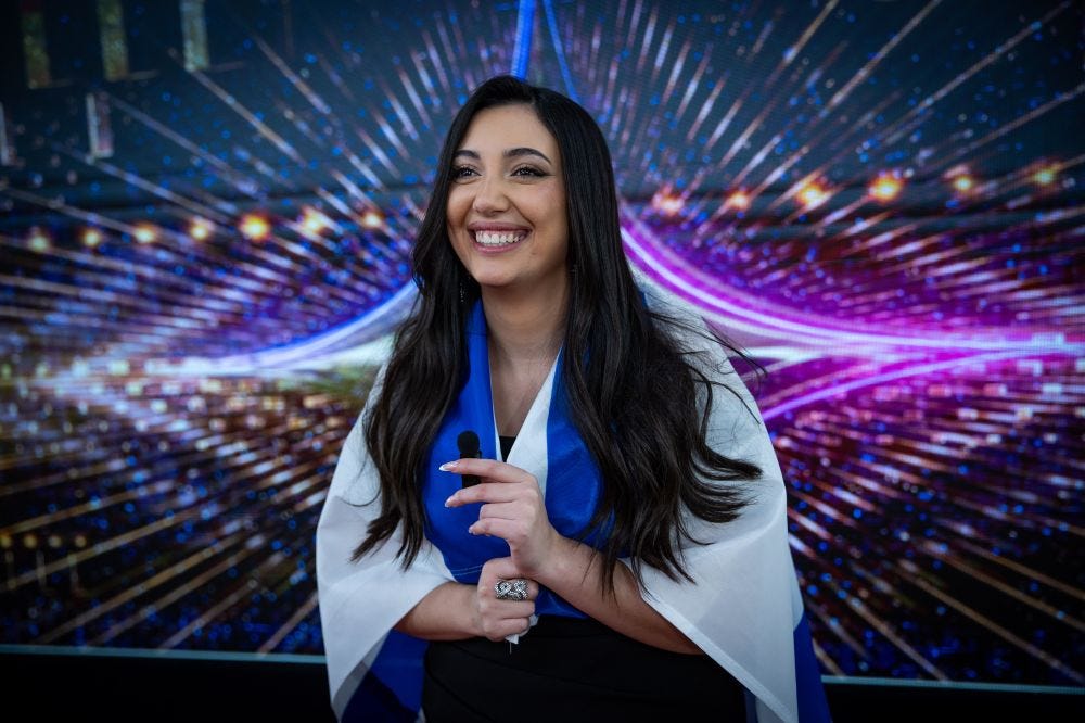 Eurovision contestant Yuval Raphael, 24, wrapped in an Israeli flag