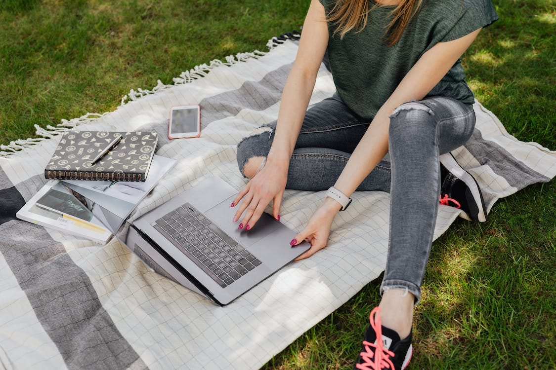 Stock photo: Slim female working on laptop while studying in park